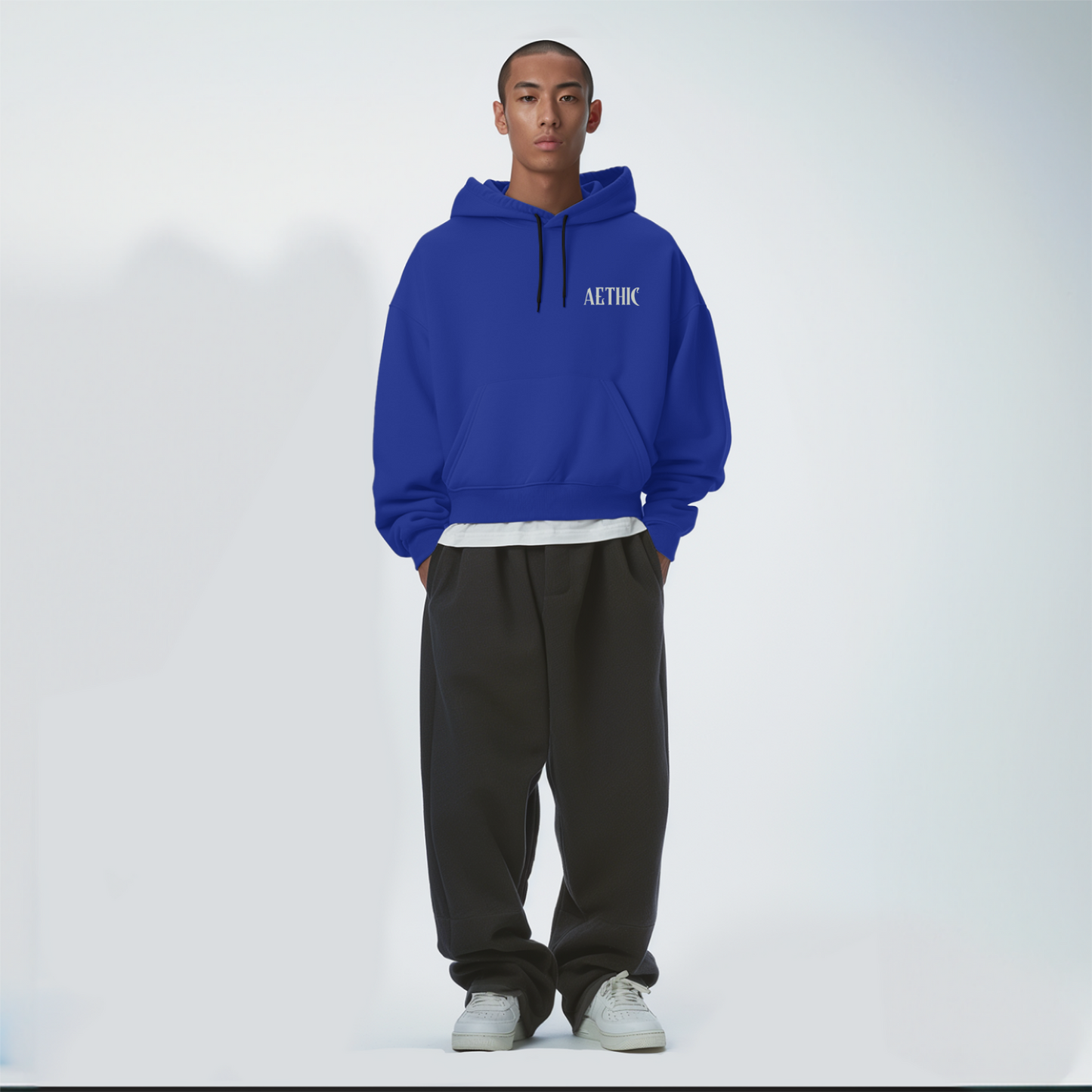 Person wearing a Royal blue hoodie with 'ALTHIC' branding on a white background