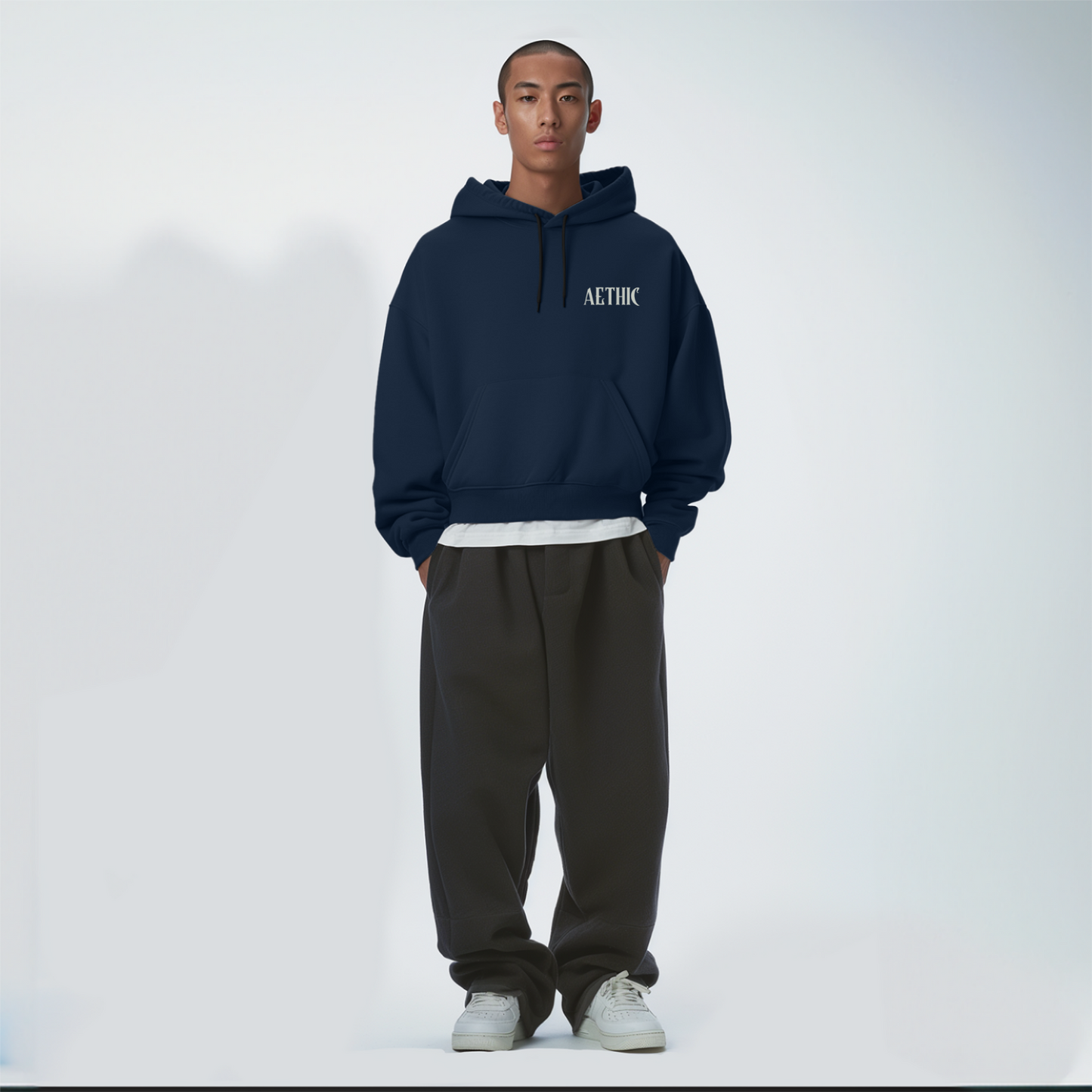 Person wearing a navy Blue hoodie with 'ALTHIC' branding on a white background