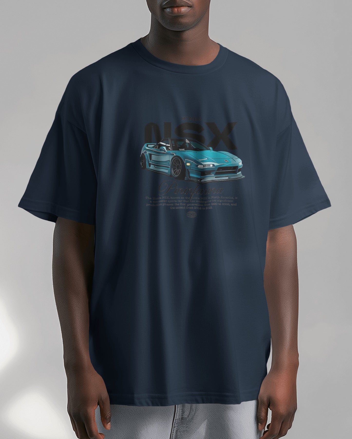 Person wearing a navy blue t-shirt with a car graphic and 'NSX' text on a gray background