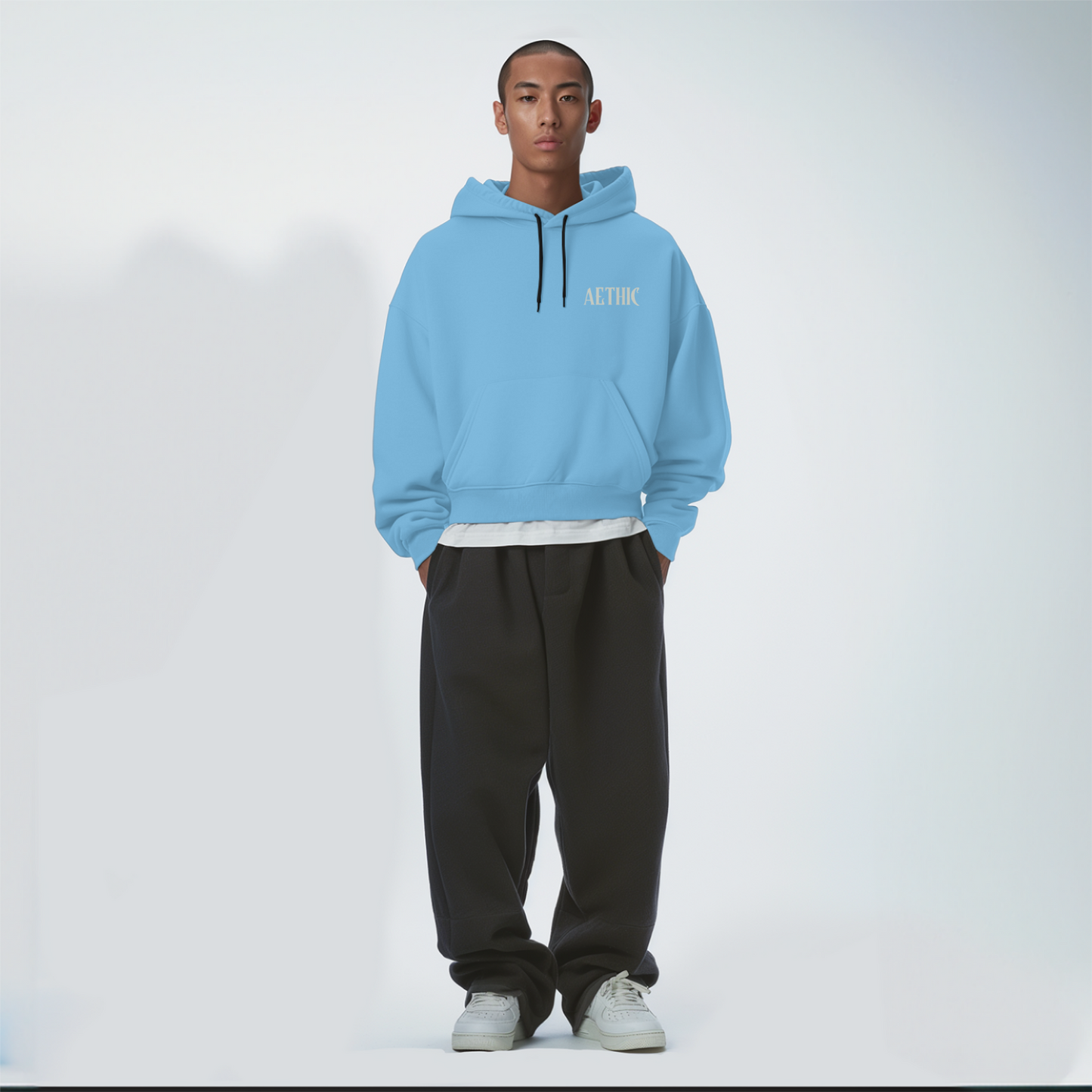 Person wearing a Baby blue hoodie with 'A-COLD-WALL*' logo on a white background