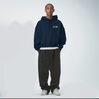 Person wearing a navy Blue hoodie with 'ALTHIC' branding on a white background
