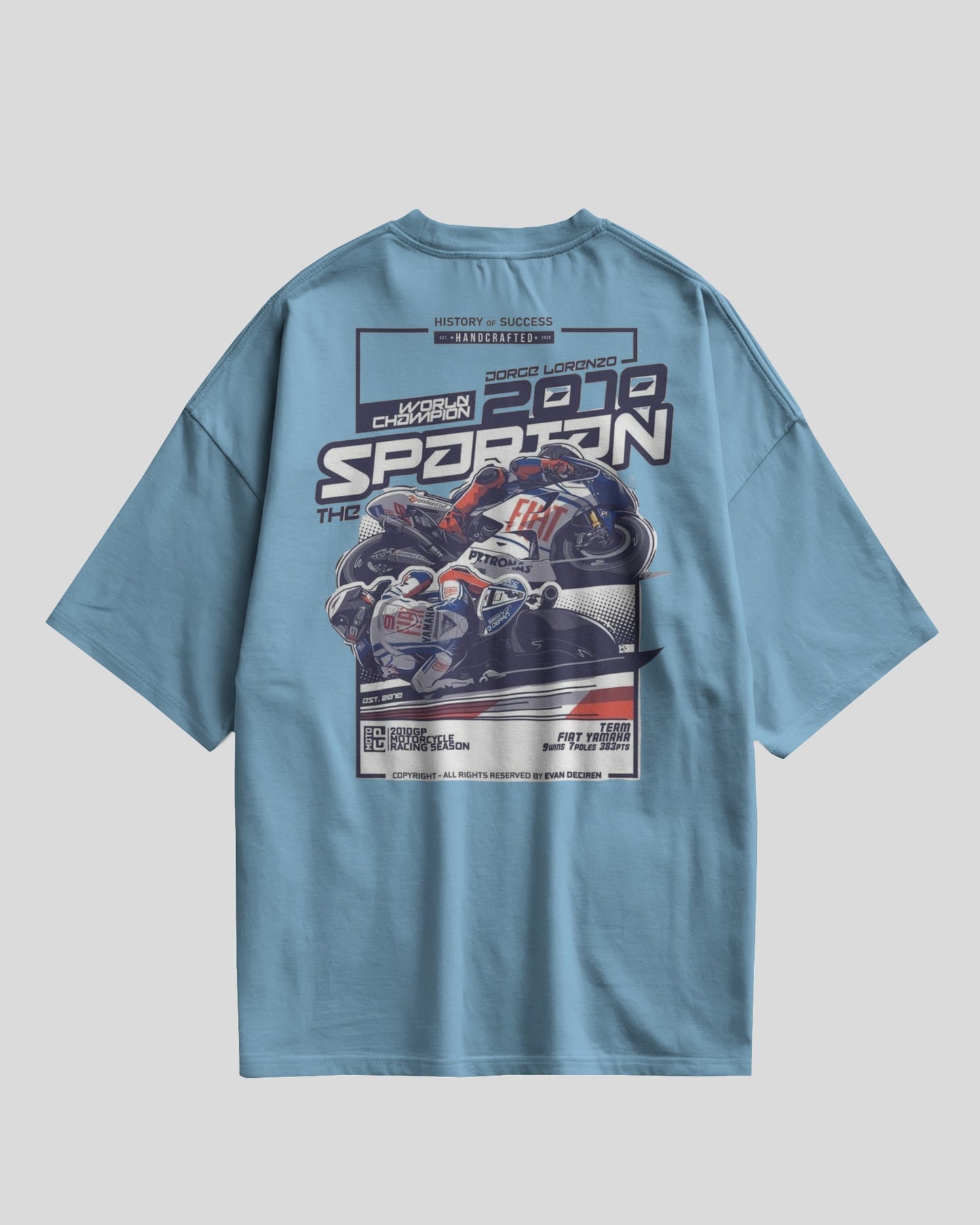 Blue t-shirt with a motorcycle graphic and text on the back against a light gray background