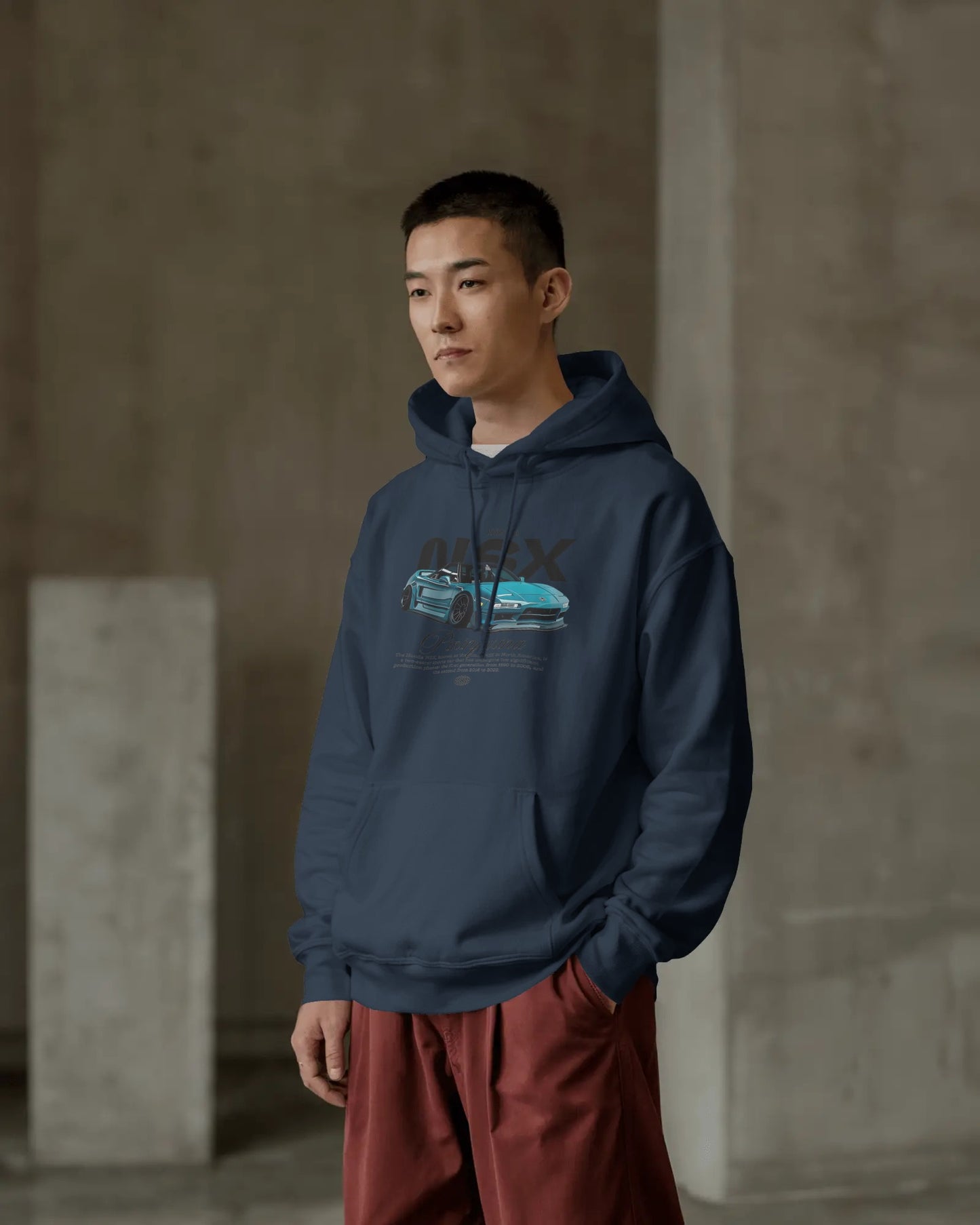 Person wearing a Colour_NavyBlue  hoodie with a graphic design in an indoor setting