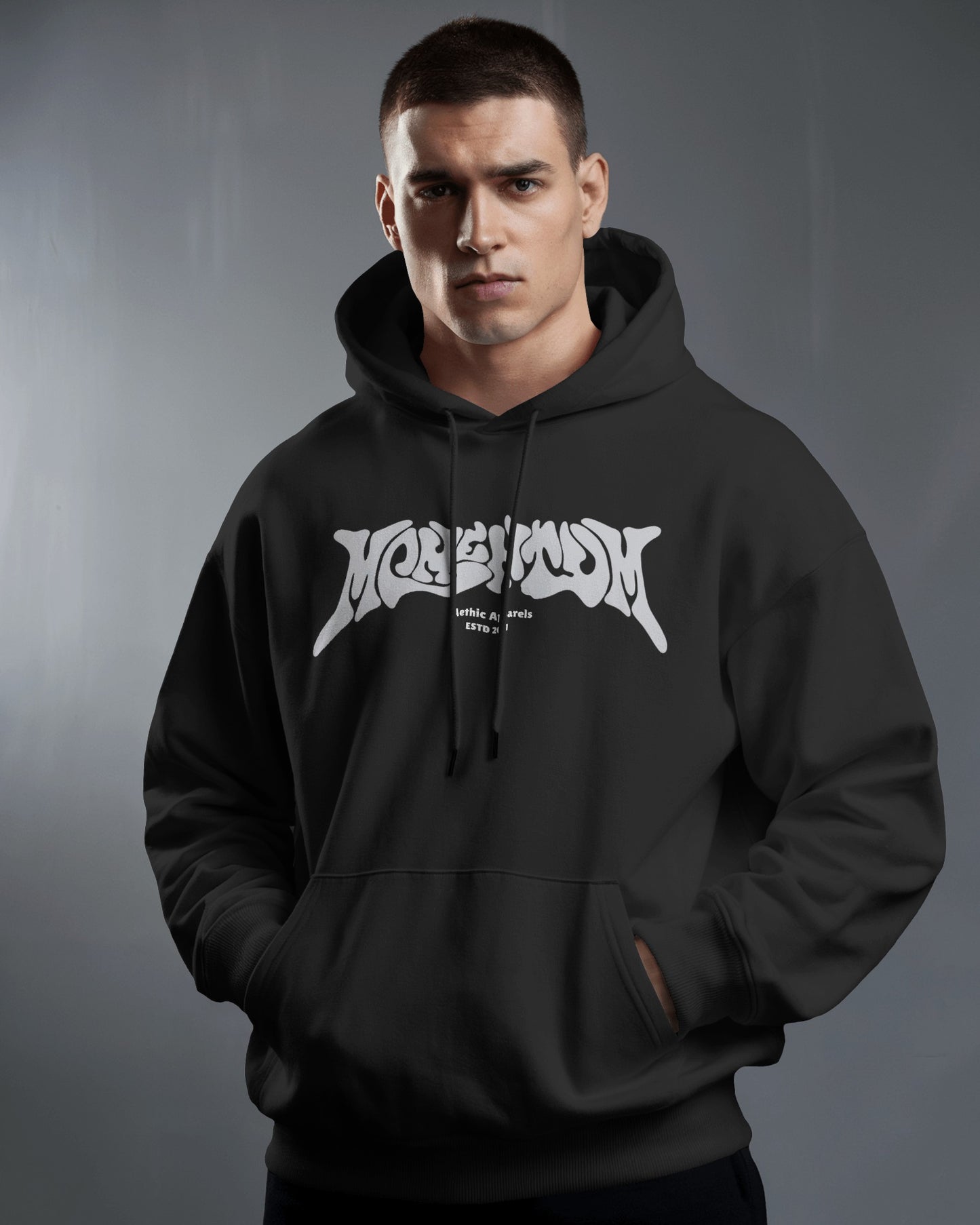 Man wearing a black hoodie with white logo against a gray background