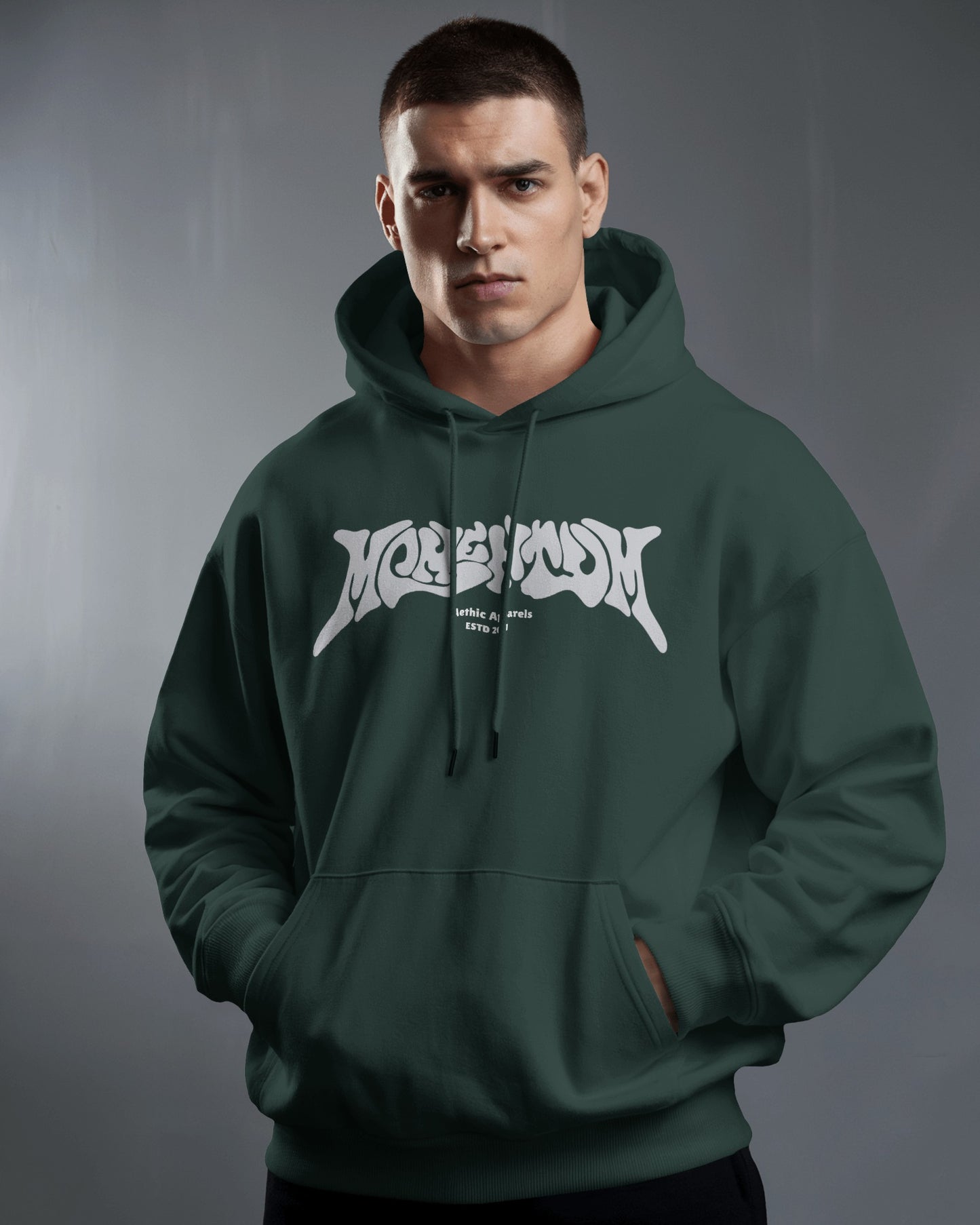 Man wearing a green hoodie with a white logo on a gray background