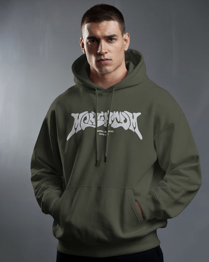 Man wearing a green hoodie with a logo on a gray background
