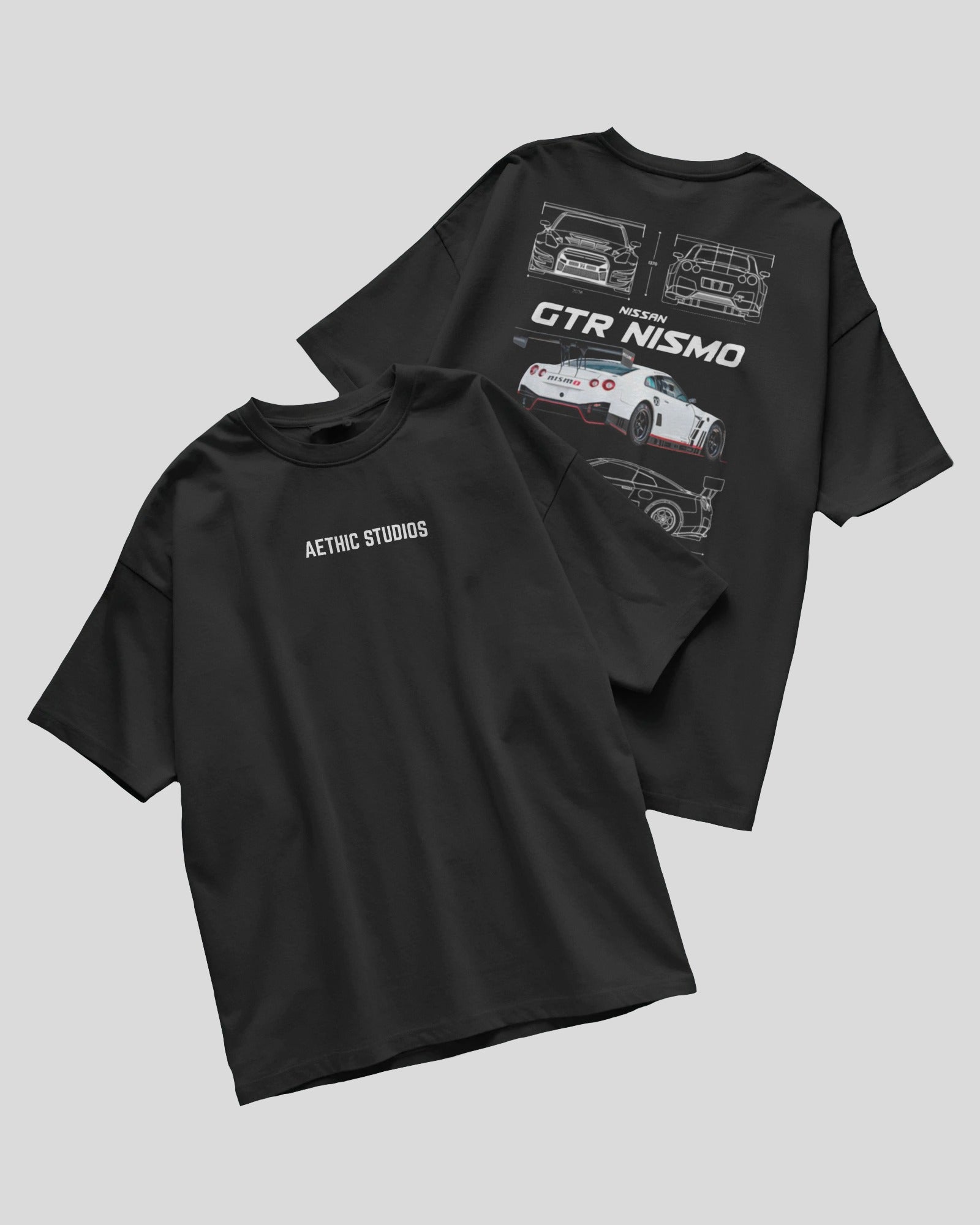 Two black t-shirts with car graphics and text on a gray background
