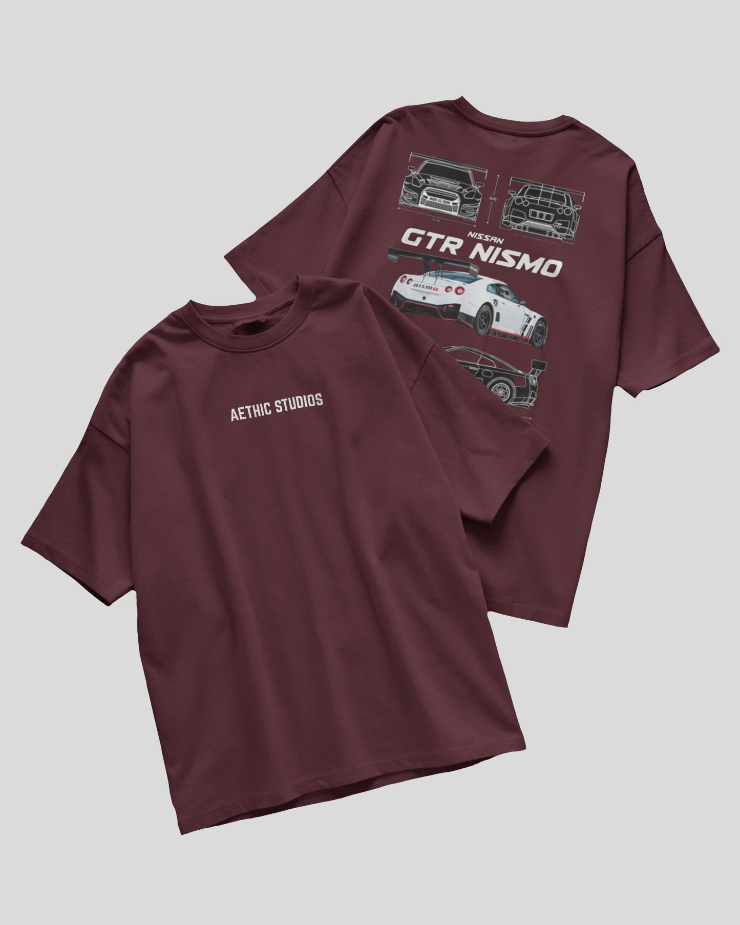 Two maroon t-shirts with car graphics and text on a light gray background