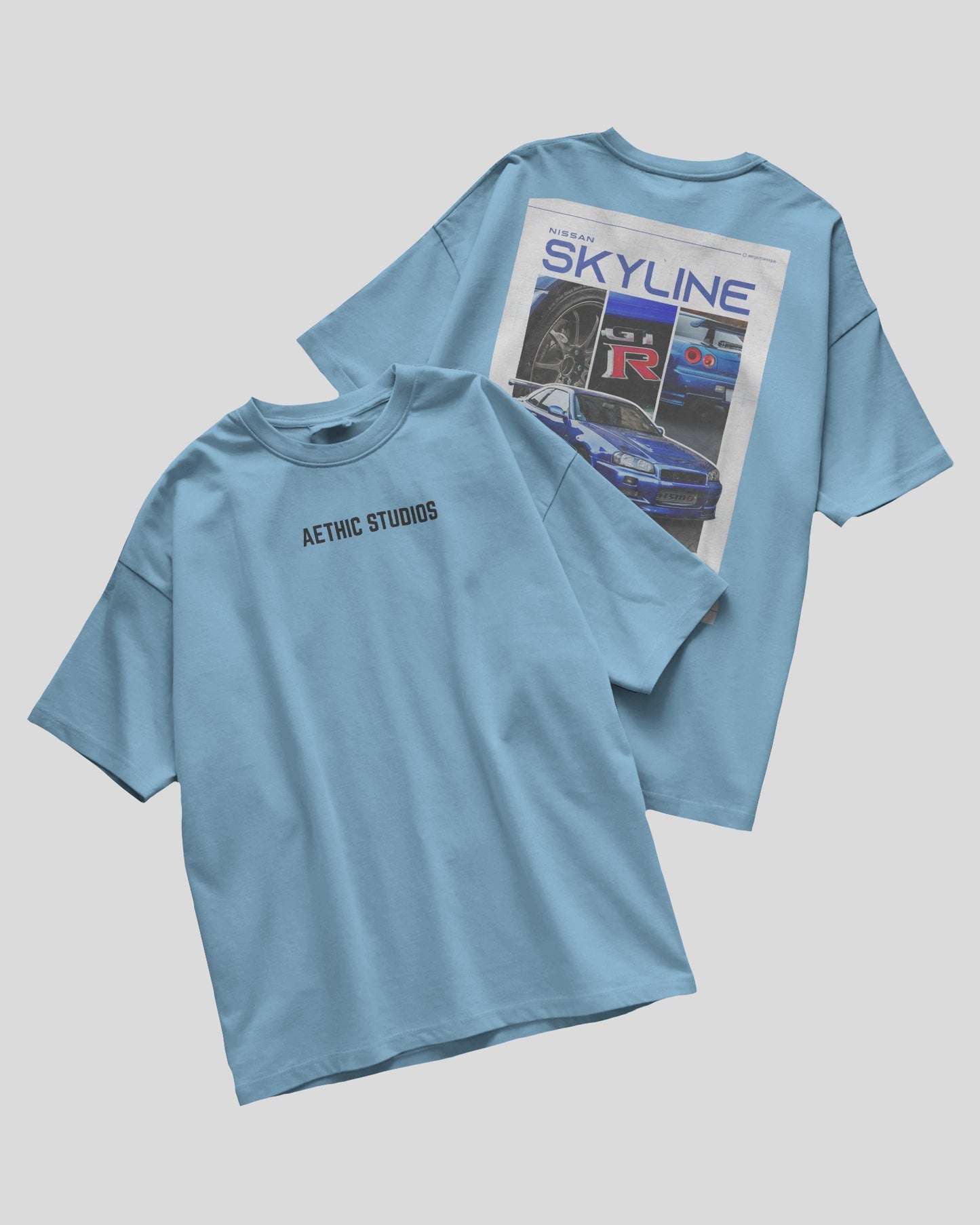 Two baby blue t-shirts with different designs on a gray background