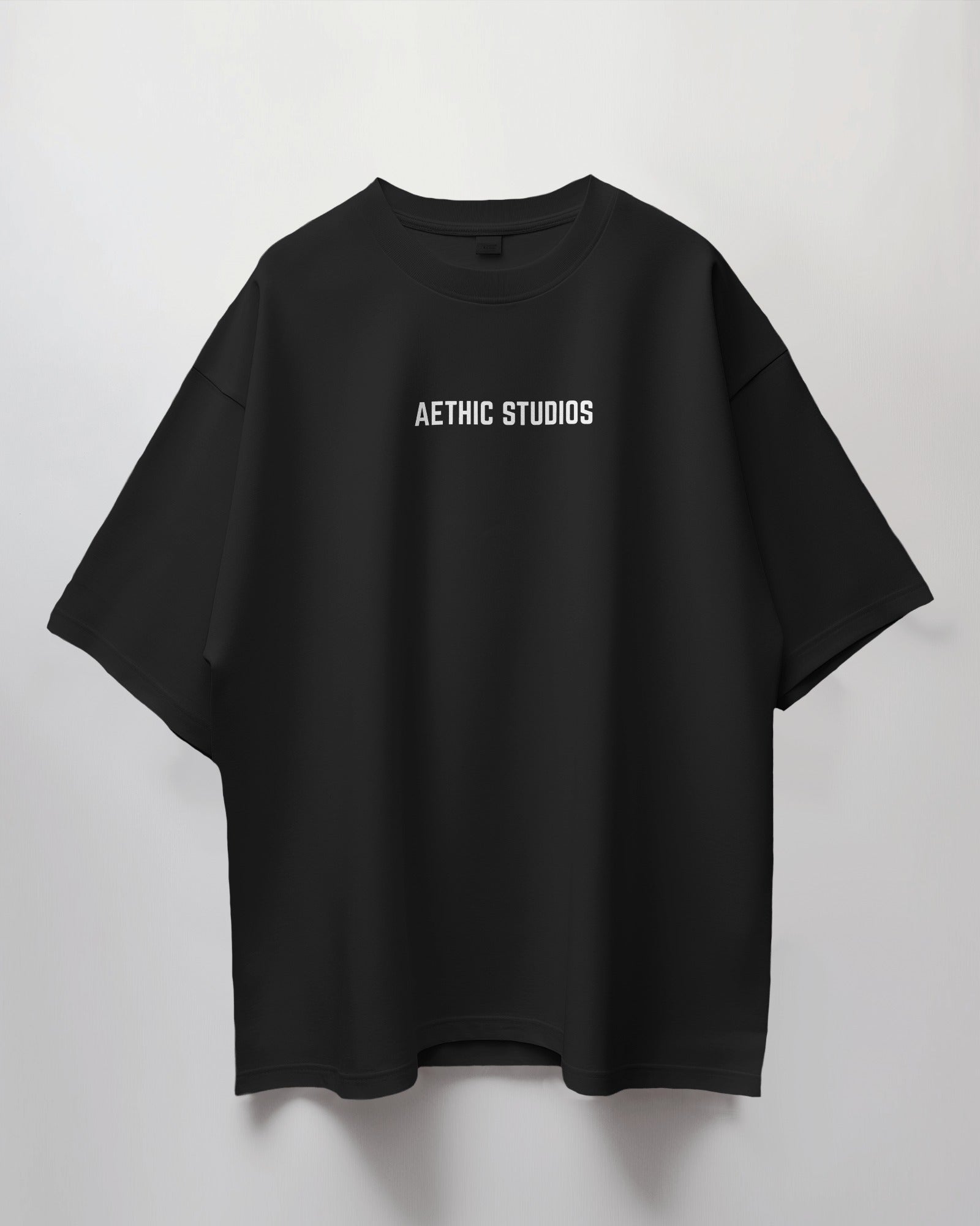Black t-shirt with 'AETHIC STUDIOS' text on a light gray background