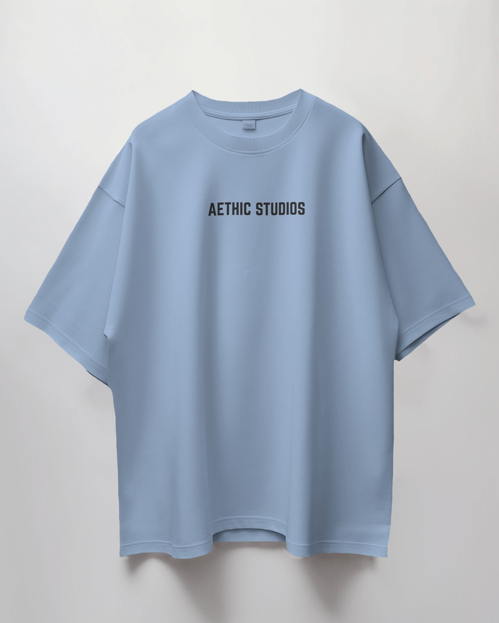 baby blue t-shirt with 'Aethic Studios' text on a light gray background