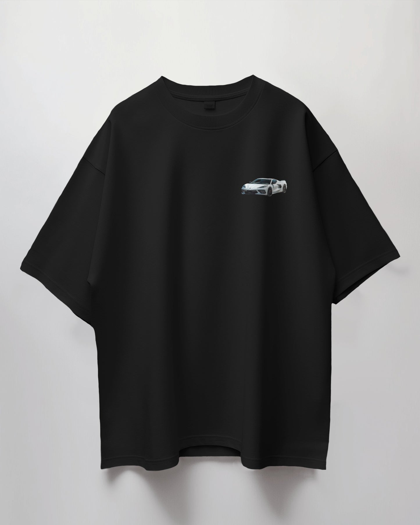 Colour_Black t-shirt with a small white car graphic on a light gray background