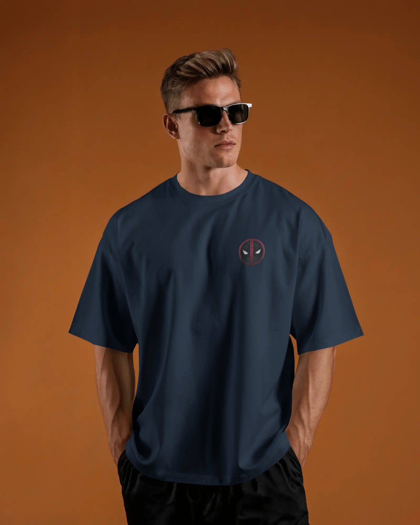 Man wearing a navy blue t-shirt with a logo of deadpool