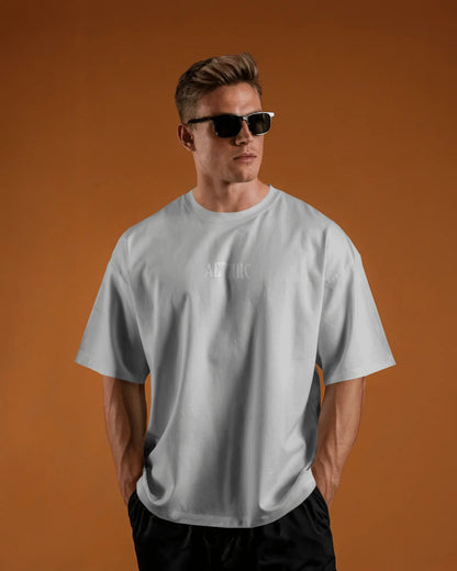 Man wearing a Colour_White t-shirt with a logo on an orange background