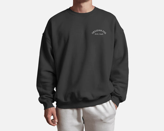 Male model wearing Obsidian Fog graphic sweatshirt in dark green color by Aethic Studios