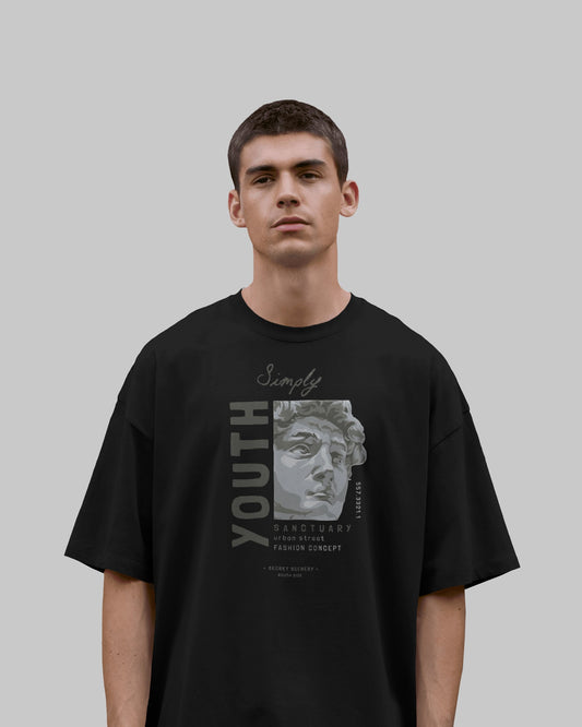 Person wearing a black t-shirt with graphic design on a plain background
