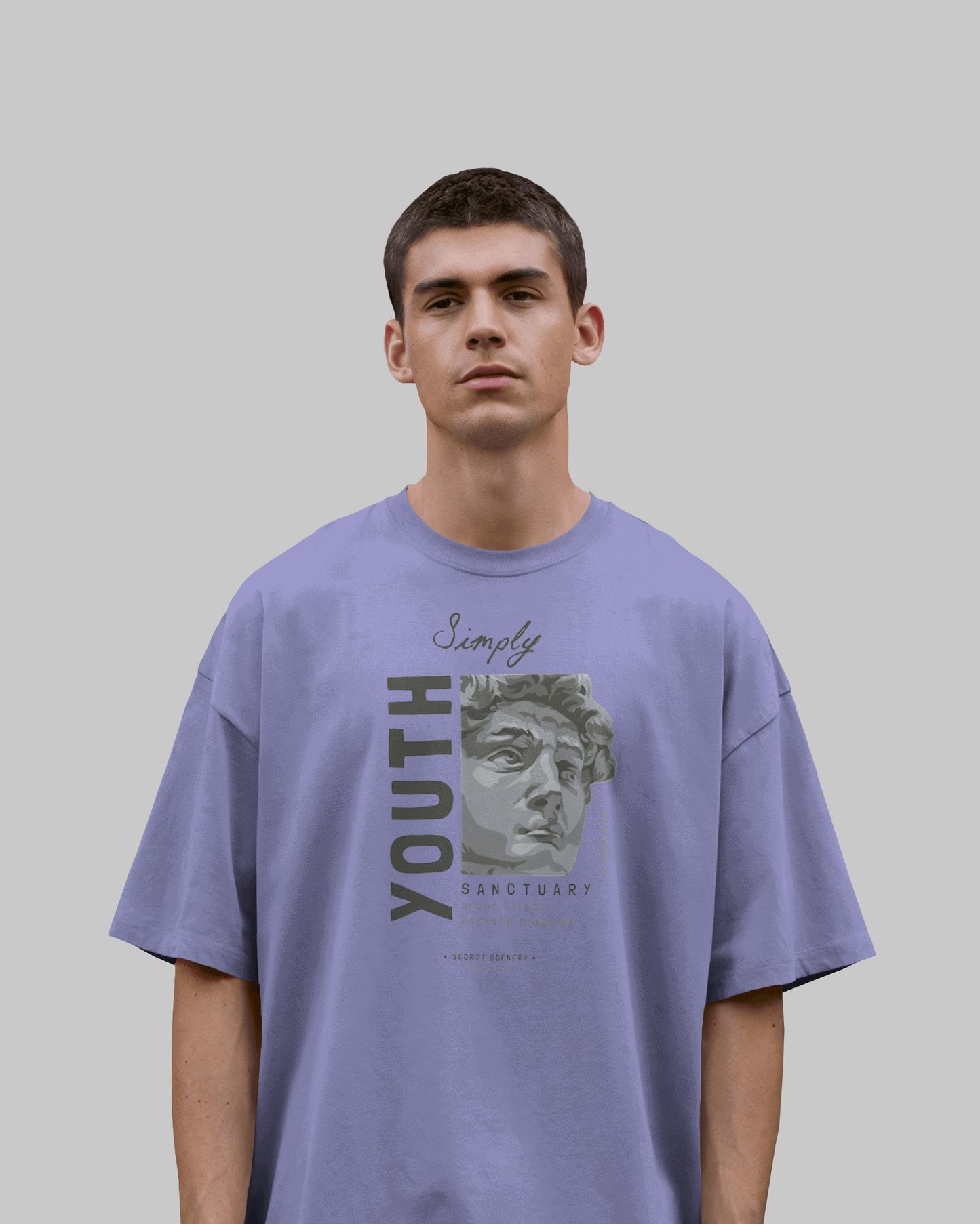 Person wearing a purple t-shirt with graphic design and text on a plain background