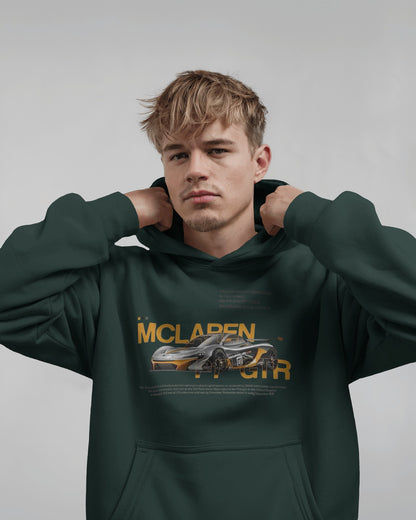 Person wearing a Colour_BottleGreen hoodie with McLaren logo on a gray background