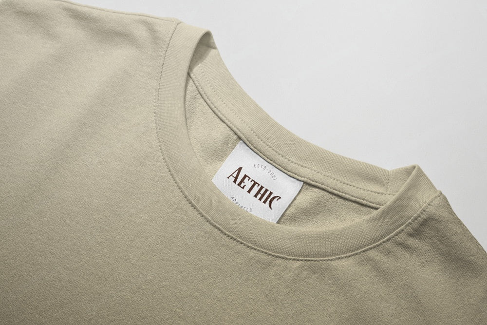 Colour_off white t-shirt with 'AETHIC' label on a light gray background